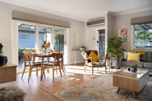un soggiorno con tavolo e sedie di Arabella Heights a Daylesford