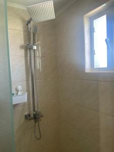 a bathroom with a shower with a window at DesSea Island-Sosua Ocean Village in Sosúa