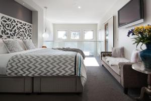 a bedroom with a bed and a couch at Arabella Meadows in Daylesford