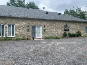 a stone house with a driveway in front of it at Q Estate Guest Suite heated indoor pool in Westport