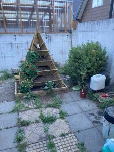 a garden with a christmas tree made out of wood at Villarrica: lago, volcán y parques naturales in Villarrica