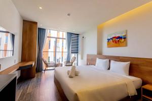 a hotel room with a bed with a teddy bear on it at Lantana House Boutique Da Nang by Haviland in Da Nang