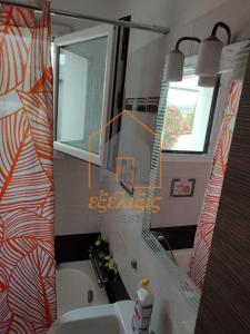 a bathroom with a sink and a mirror at Niki House in Volos