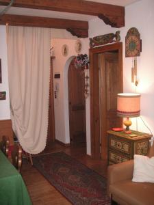 a living room with a couch and a table and a door at Ca' dello Scoiattolo in Cortina dʼAmpezzo