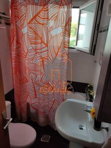 a bathroom with a shower curtain and a sink at Niki House in Volos +31 photos