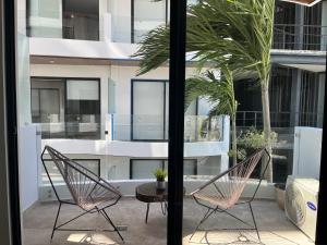 a patio with two chairs and a table at Menesse Midtown 2 206 y 209 in Playa del Carmen