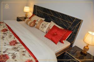 a bed with two pillows on it in a bedroom at Khyber Guest House Swat in Saidu