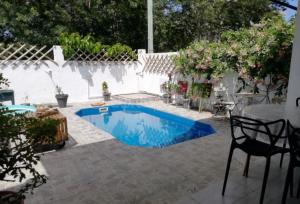 a swimming pool in a patio with a table and chairs at Mathilde Villa Grand Baie in Grand Baie