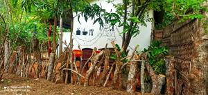 una señal en el lateral de un edificio con árboles en Sigiri Picaso Home Stay, en Sigiriya