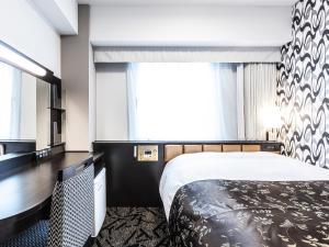 a hotel room with a bed and a large window at APA Hotel Roppongi SIX in Tokyo