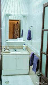 a white bathroom with a sink and a mirror at Casona Rosa B&B, Morelia in Morelia