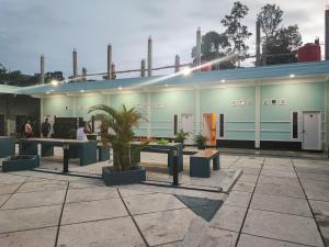 a building with tables in front of it at RedDoorz Syariah at Naffa Homestay in Sarolangun