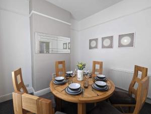 a dining room with a wooden table and chairs at Victoria House in Scarborough