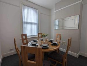 a dining room with a wooden table and chairs at Victoria House in Scarborough