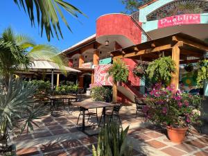 ココにあるMariposa End Unit Loftのレストランの前にテーブルと椅子付きのパティオ