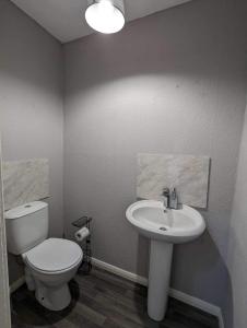 a bathroom with a toilet and a sink at Victoria House in Scarborough