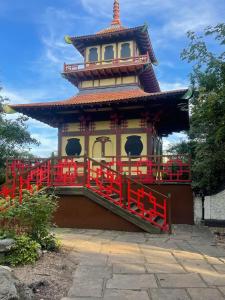 a pagoda with a red fence in front of a building at Victoria House in Scarborough