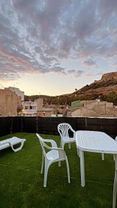two white chairs and a table on a roof at CASA DEL CASTILLO in Alicante