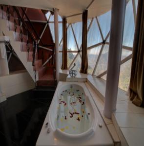 a bathroom with a bath tub with animals in it at Tarika Resort & Spa , Chail in Chail
