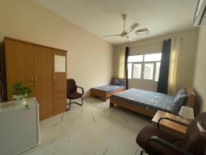 Zimmer mit einem Schlafzimmer mit einem Bett und einem Stuhl in der Unterkunft old muscat in Muscat