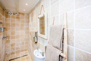 a bathroom with a toilet and a sink at Sandpipers, Boutique Cottage With Wow Sea Views In Amazing Location in Sennen