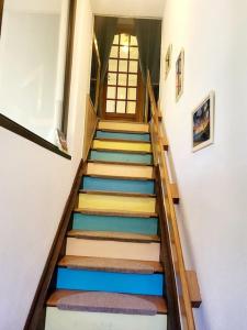 a staircase with colorful steps in a building at TI CAZ PYRENEES (Chambre d'Hôtes) in Mirepeix
