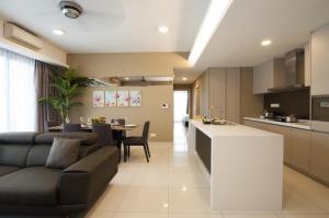 a kitchen and living room with a couch and a table at Suasana Suites Bukit Ceylon in Kuala Lumpur