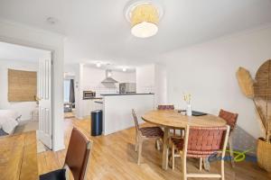 a kitchen and dining room with a table and chairs at River Dais in Wellington East