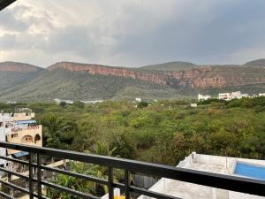a view of the mountains from the balcony of a house at SSN Home Stays in Tirupati Near Alipiri in Tirupati