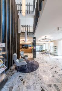 a lobby with a chair and a table at Hotel-Restaurant Grimmingblick in Bad Mitterndorf