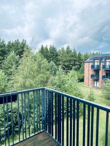 a balcony with a black railing and a building at Isco Apartment in Kuressaare