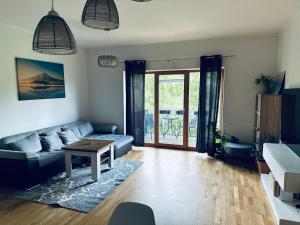 a living room with a couch and a table at Isco Apartment in Kuressaare +11 photos