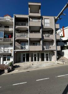 an apartment building with balconies on the side of a street at Guest House Mrvaljević in Budva