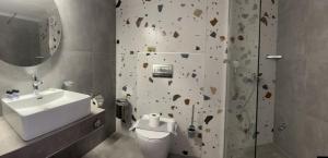 a bathroom with a rock climbing wall next to a sink at Ellas Hotel in Skala Potamias