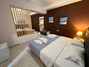 a bedroom with a large bed with towels on it at Golden days in Afantou