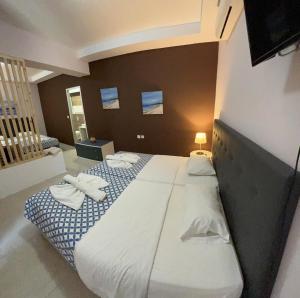 a bedroom with a large bed with towels on it at Golden days in Afantou