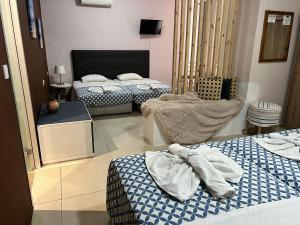 a bedroom with two beds with towels on them at Golden days in Afantou