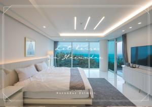 a bedroom with a bed and a large window at 500m2 Busan Ocean view private Let house 부산 오션뷰 3개층 대저택 독채펜션 렛하우스 in Busan