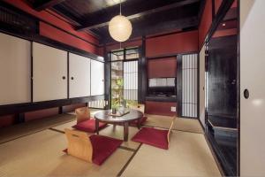 a room with a table and chairs in a room at Suo an Machiya House in Kyoto