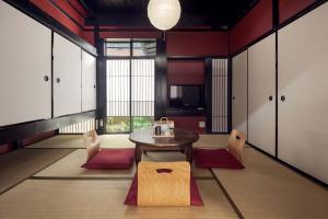 a dining room with a wooden table and chairs at Suo an Machiya House in Kyoto