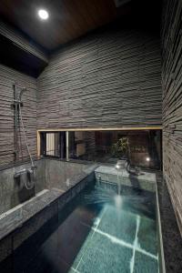 a large swimming pool in a room with a large window at Suo an Machiya House in Kyoto