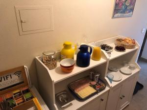 a shelf with various items on top of it at Gästehaus Lehnerer Grainau in Grainau