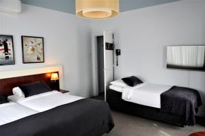 Postel nebo postele na pokoji v ubytování Apollo Hotel