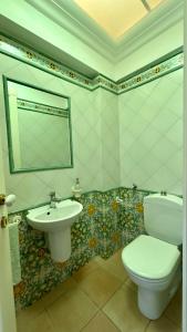 a bathroom with a toilet and a sink at Mie sorelle (tra cielo e mare) in Ventimiglia