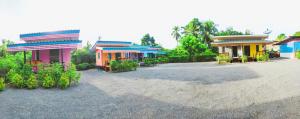 a group of colorful buildings in a parking lot at ณัฐวดี รีสอร์ท in Don Sak