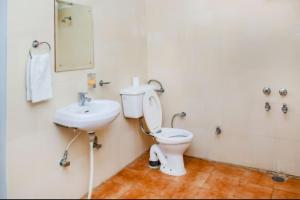 a bathroom with a toilet and a sink at Aestus Adventure and Wellness Centre in Kasauli