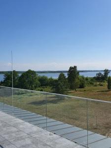 a balcony with a view of the water at Sea & Lake Apartament 17, 317 Molo Mielno Sosnowy Las 15 in Mielno