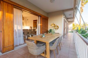 a wooden table and chairs on a balcony at Villa Antiope Saronida in Saronida