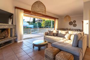 a living room with a couch and a fireplace at Villa Antiope Saronida in Saronida