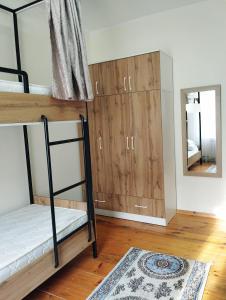 a room with bunk beds and a mirror at Salma Capsule Hostel in Bishkek